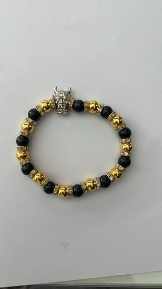 Angelito Negro – Pulsera dorada cabra calavera negra y dorada