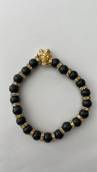 Angelito Negro – Pulsera negra brillantes calavera cabra dorada
